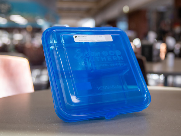 The ReusePass to-go container is made from a durable hard plastic in a very recognizable blue color.