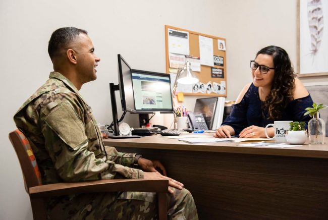 A military student talks with a Georgia Southern employee.