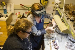 Governor's Awards for the Arts & Humanities 2016, In Progress, Professor Christina Lemon, Student Madeline Shelor work on the lotus blossom portion of the 2016 Governor's Awards for the Arts & Humanities, designed by alumni Shaunté Francois.
