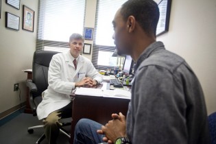 Dr. Brian DeLoach talks with a patient at Georgia Southern University Health Services.