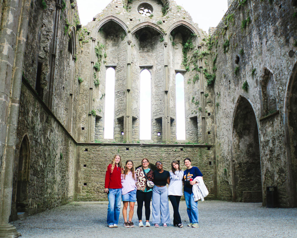 Group of Georgia Southern students standing in front of cathedral ruins in Ireland.