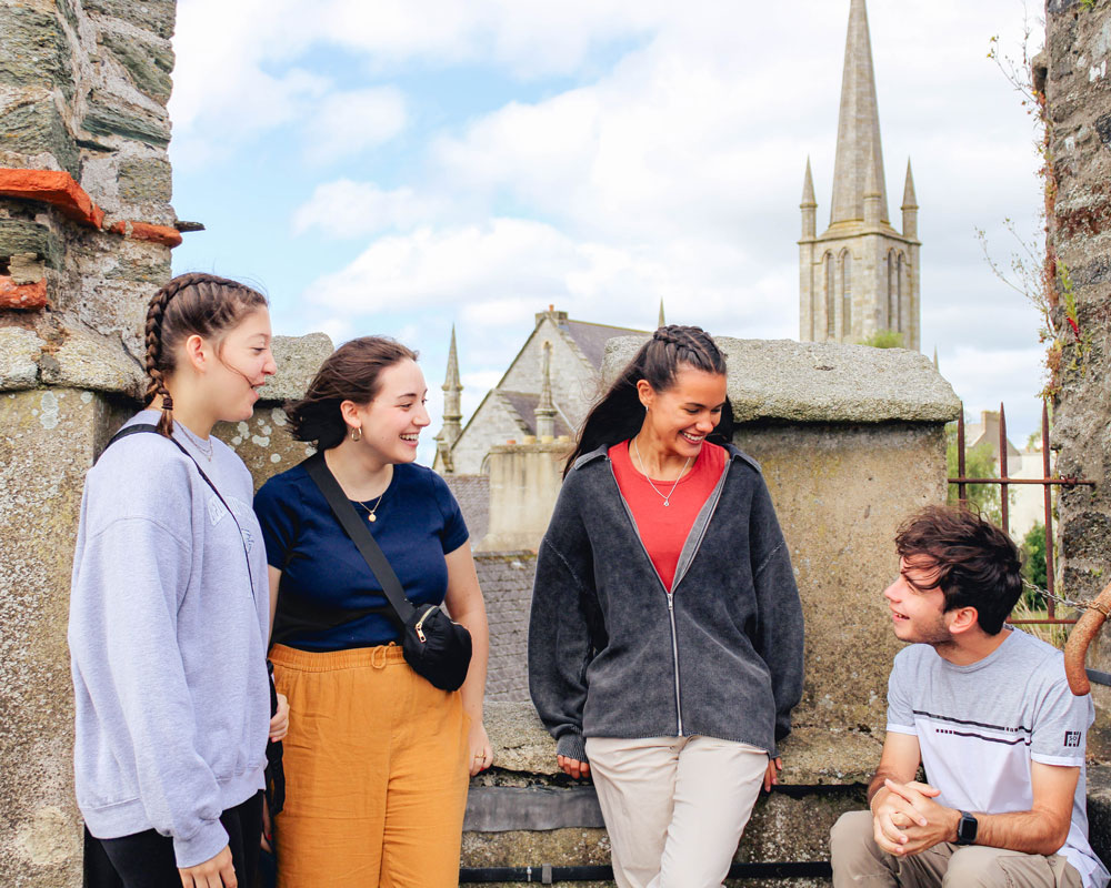 Group of Georgia Southern students in Ireland with cathedral in the background.