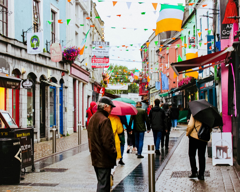 Bright colorful city streets in Ireland bustling with people.