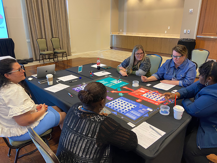 Participants are playing a medical simulation board game about hospital operations.