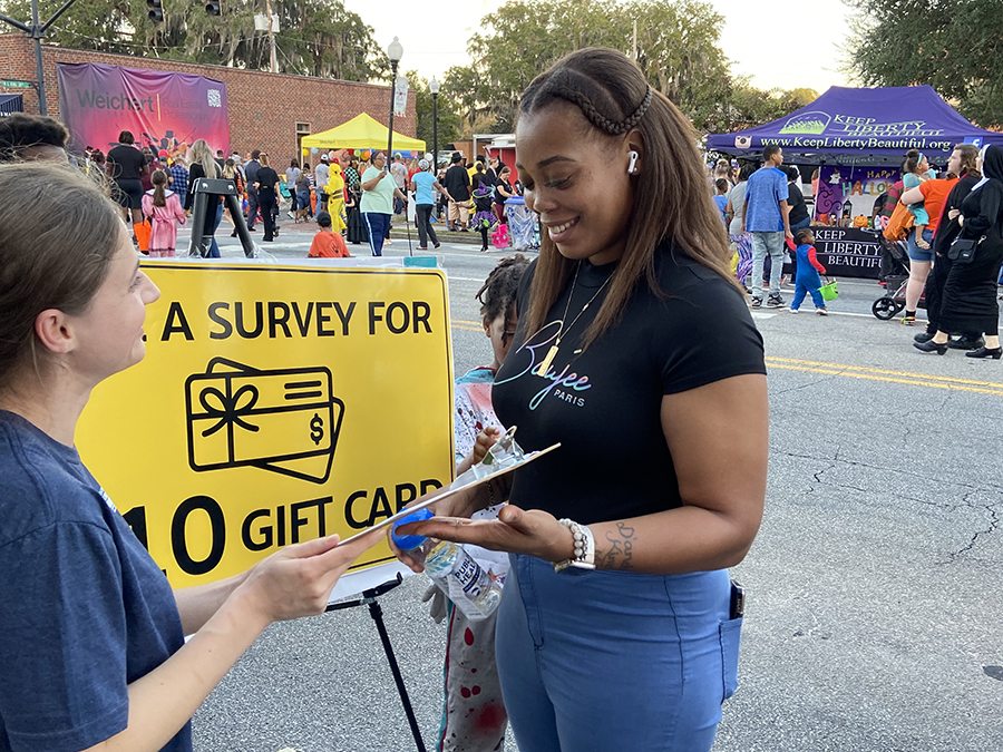 Student asking someone to complete a research survey.