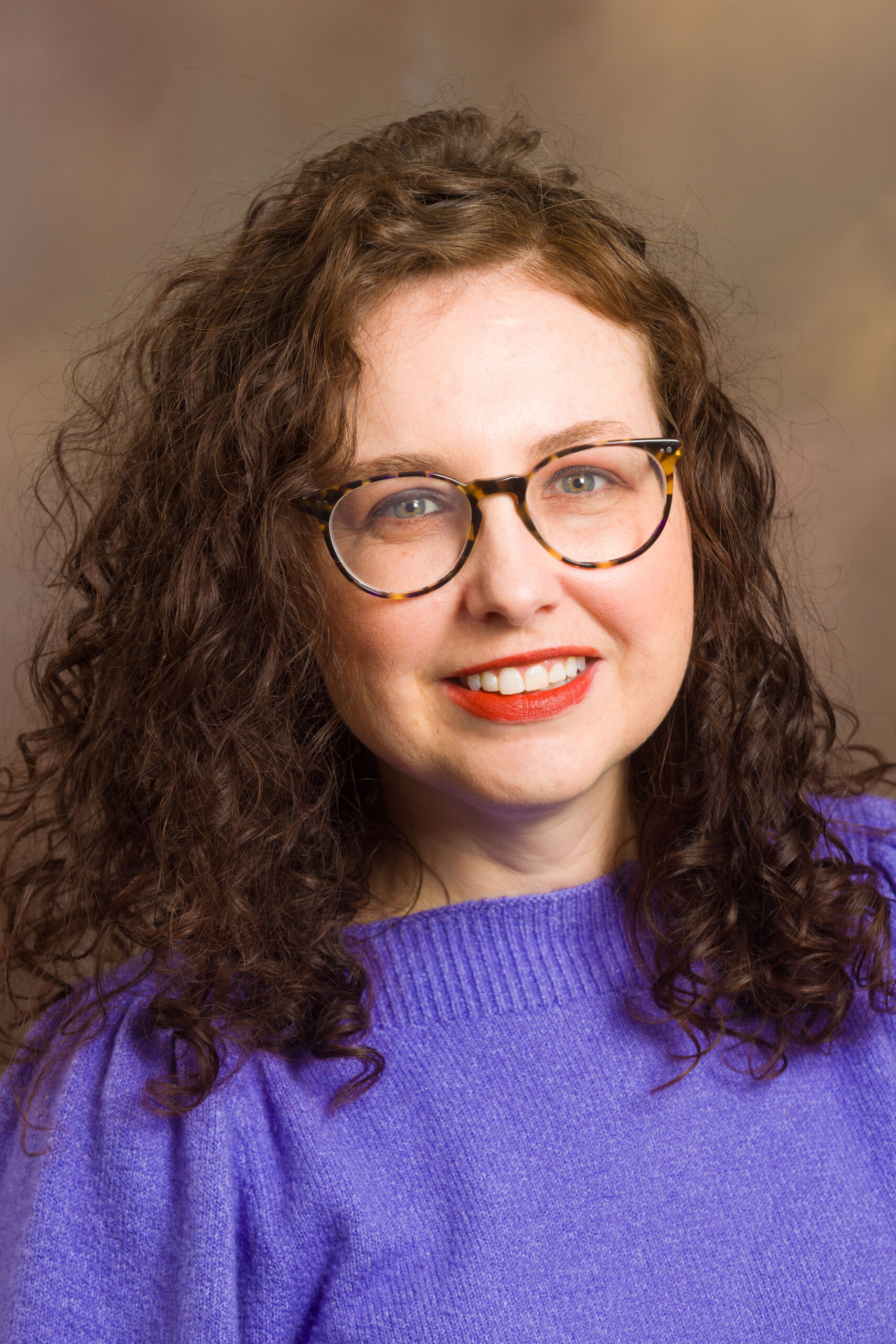 Amy Potter wearing glasses and a purple sweater