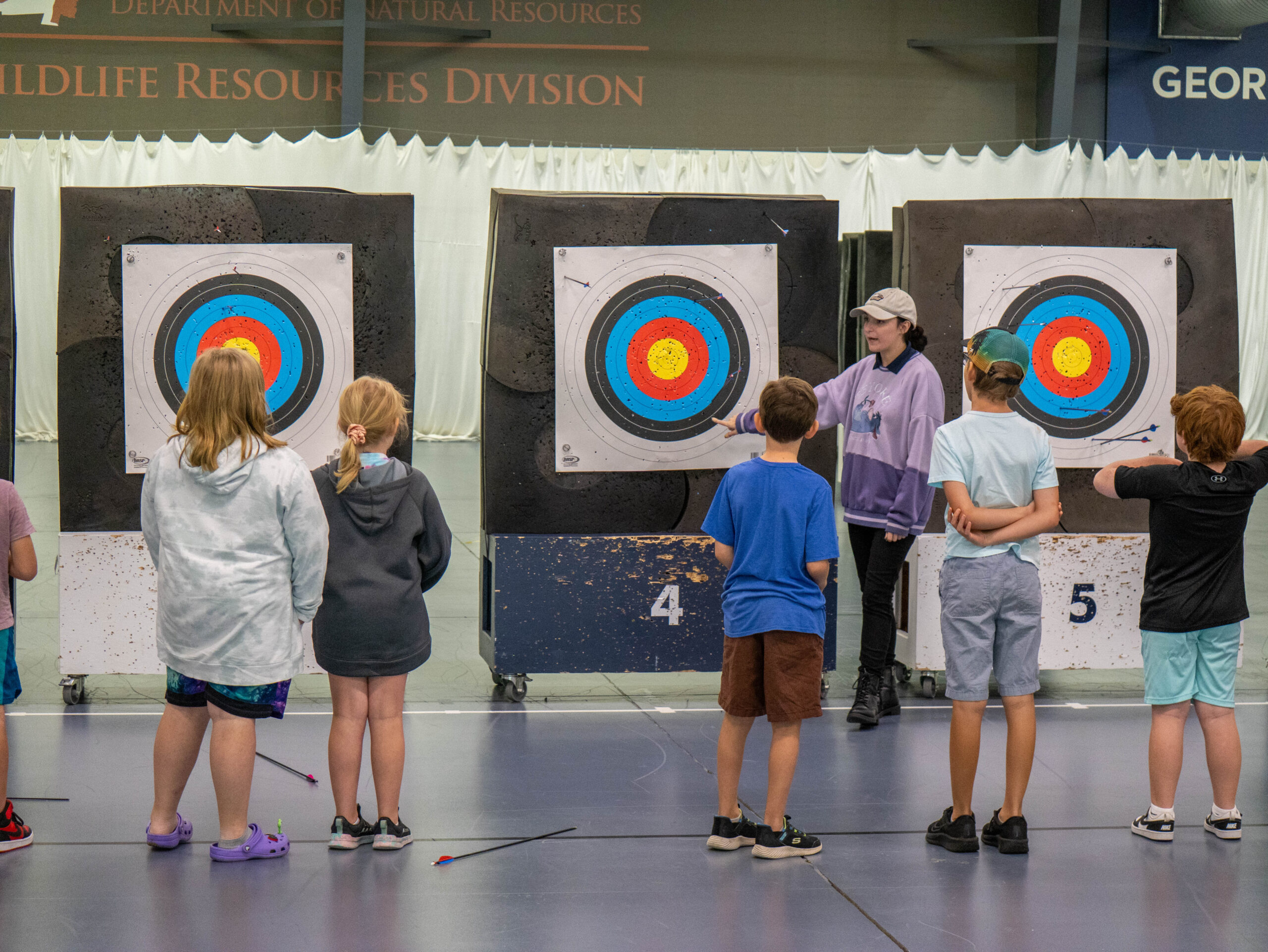 Kids watching instructor at the Shooting Sports Summer Camp