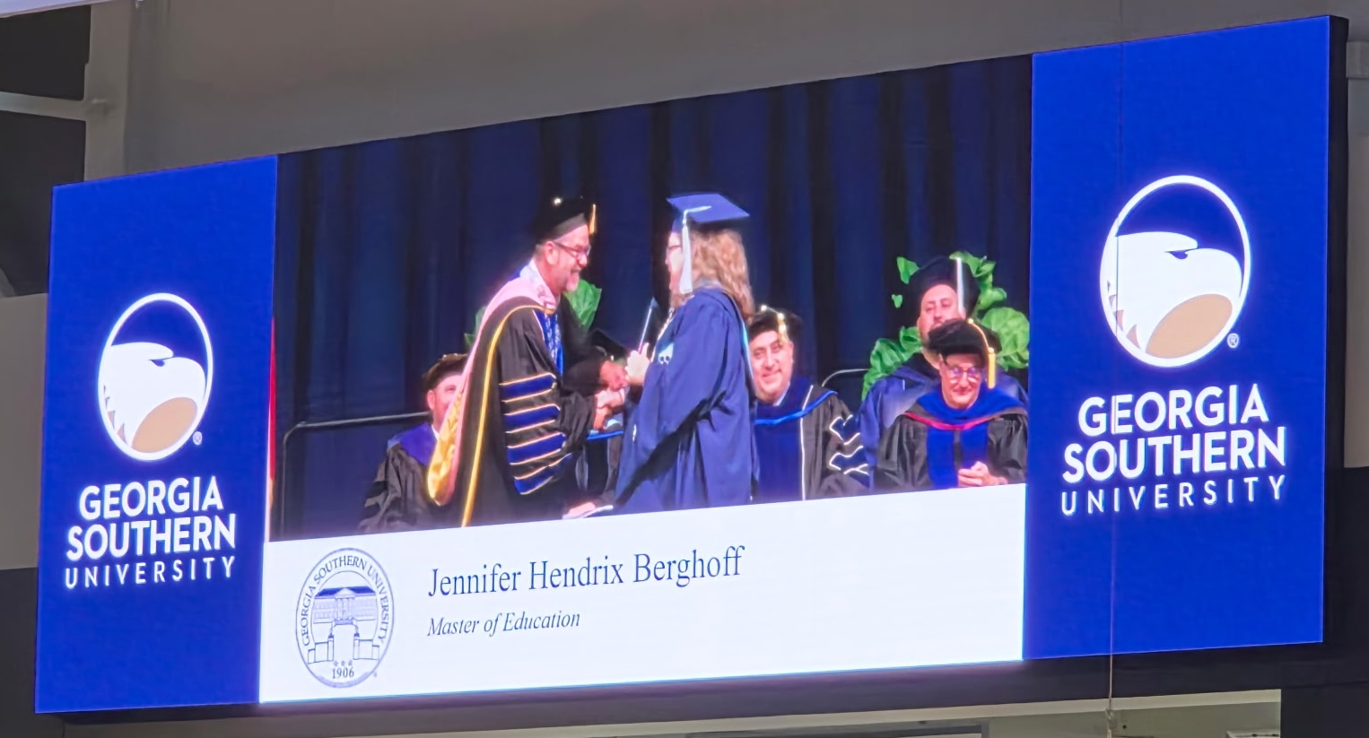 Jennifer Berghoff walks across the stage to receive her Master of Education degree.