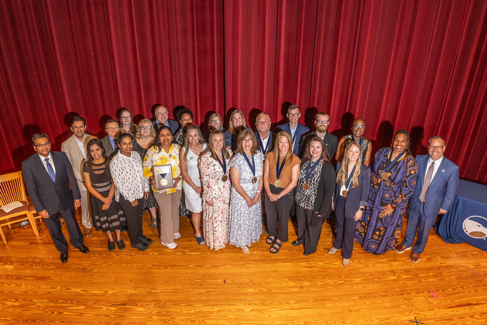 Award winners stand together holding awards at Georgia Southern University Awards of Excellence ceremony